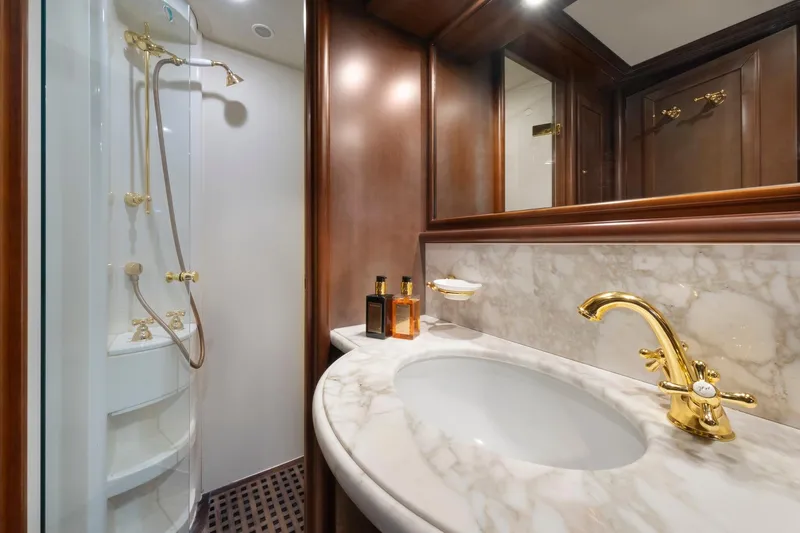 Hag Yacht Photos Pics Luxurious bathroom in 2007 Custom Line Navetta 30 yacht with marble sink and gold fixtures.
