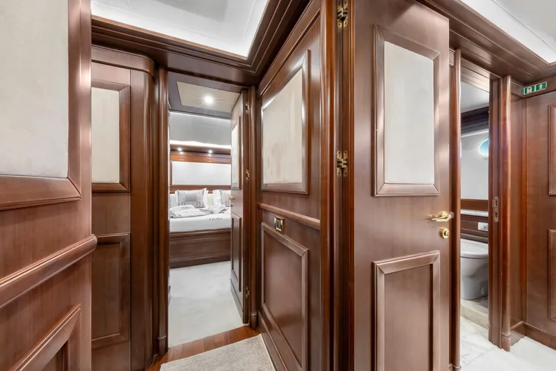 Hag Yacht Photos Pics Luxurious wooden interior of 2007 Custom Line Navetta 30 yacht, featuring elegant doors and hallway.