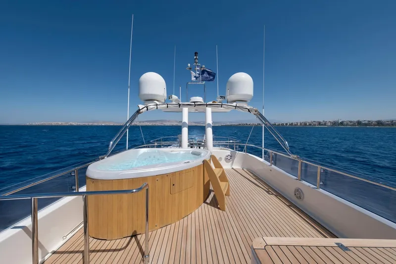 Hag Yacht Photos Pics Luxurious 2007 Custom Line Navetta 30 yacht deck with hot tub, cruising on open sea.