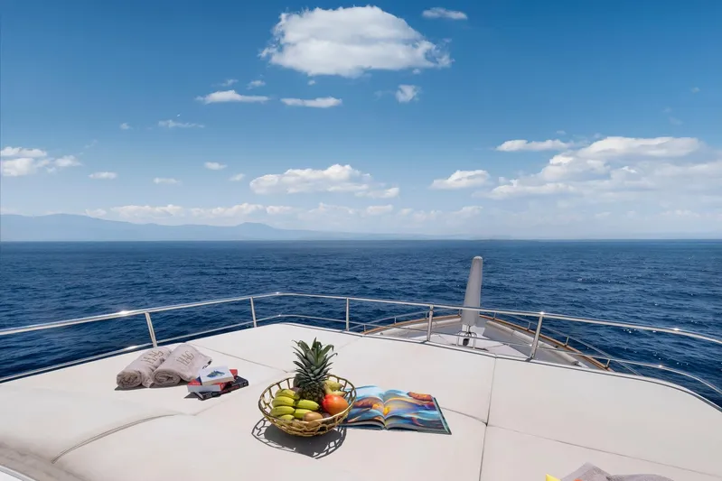 Hag Yacht Photos Pics Luxurious 2007 Custom Line Navetta 30 yacht deck with fruit basket, towels, and ocean view.