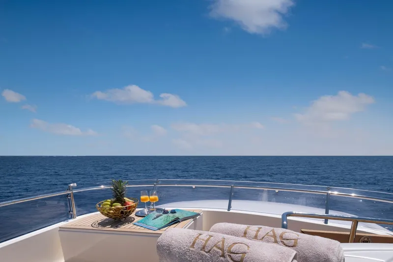 Hag Yacht Photos Pics Luxurious deck view on 2007 Custom Line Navetta 30 yacht, featuring ocean horizon and refreshments.