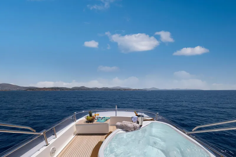 Hag Yacht Photos Pics Luxurious Custom Line Navetta 30 yacht deck with jacuzzi, ocean view, and clear blue sky.