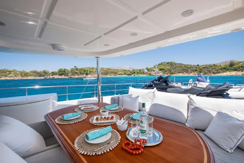 Hag Yacht Photos Pics Luxurious 2007 Custom Line Navetta 30 yacht with elegant dining setup and scenic ocean view.