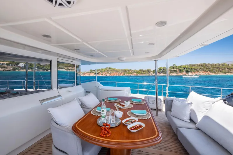 Hag Yacht Photos Pics Luxurious 2007 Custom Line Navetta 30 yacht with elegant dining setup and scenic ocean view.