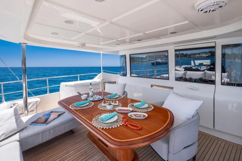 Hag Yacht Photos Pics Luxurious 2007 Custom Line Navetta 30 yacht deck with elegant dining setup and ocean view.