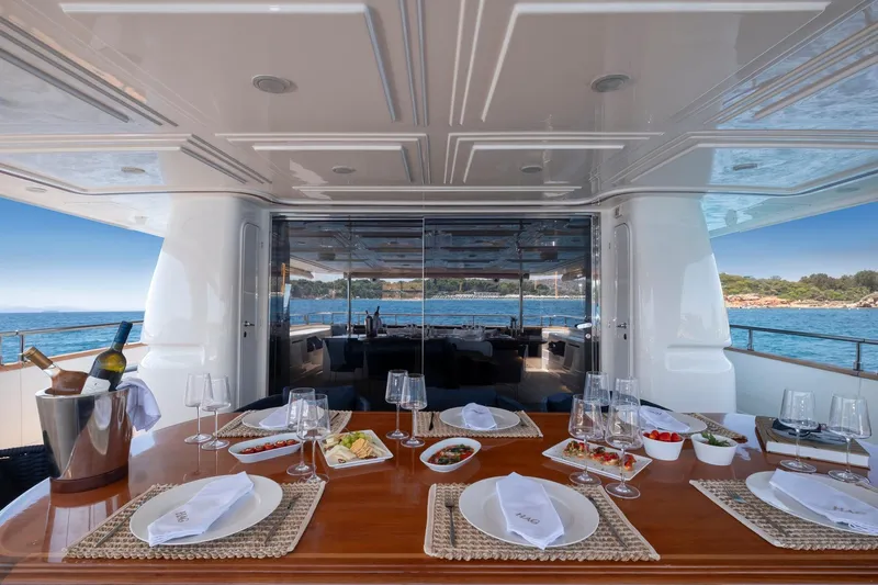 Hag Yacht Photos Pics Luxurious dining setup on 2007 Custom Line Navetta 30 yacht, overlooking serene ocean view.