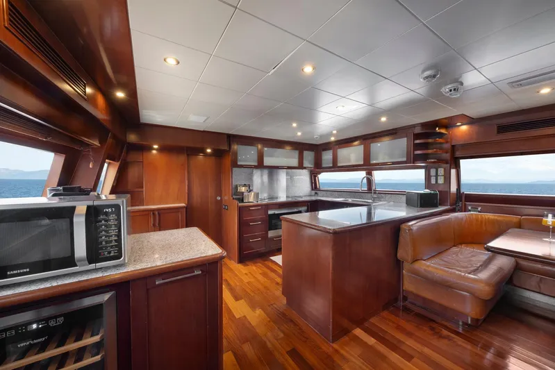 Hag Yacht Photos Pics Luxurious interior of 2007 Custom Line Navetta 30 yacht with modern kitchen and seating area.