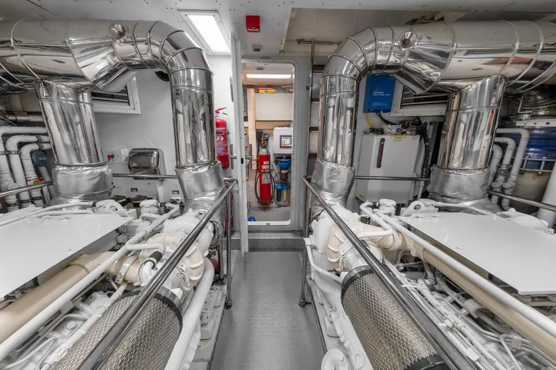 Hag Yacht Photos Pics Engine room of 2007 Custom Line Navetta 30 yacht, featuring polished metal pipes and machinery.