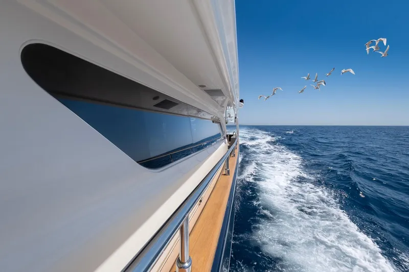 Hag Yacht Photos Pics Custom Line Navetta 30 yacht cruising on open sea, 2007 model, with seagulls flying nearby.