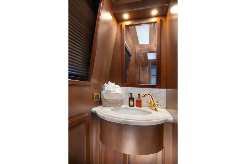 Hag Yacht Photos Pics Luxurious bathroom on 2007 Custom Line Navetta 30 yacht with elegant wood and marble finishes.
