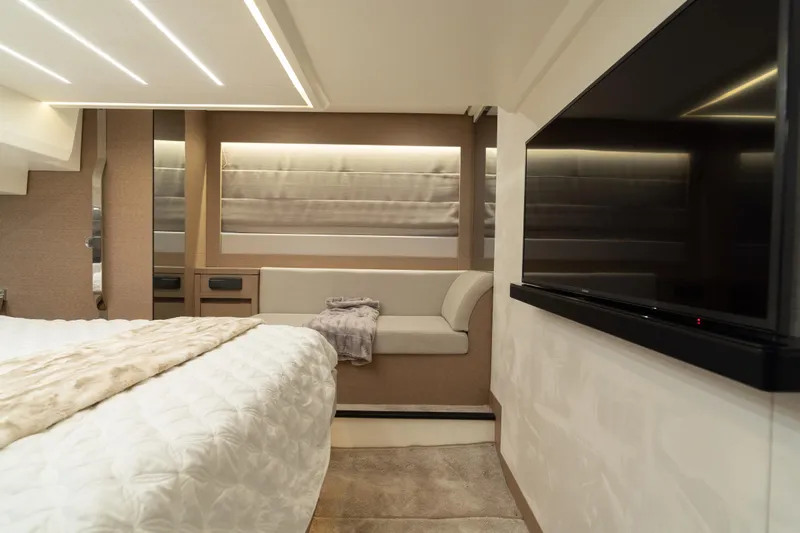 Motivated Seller Yacht Photos Pics Luxurious interior of a 2019 Prestige 520 yacht with modern decor and a flat-screen TV.