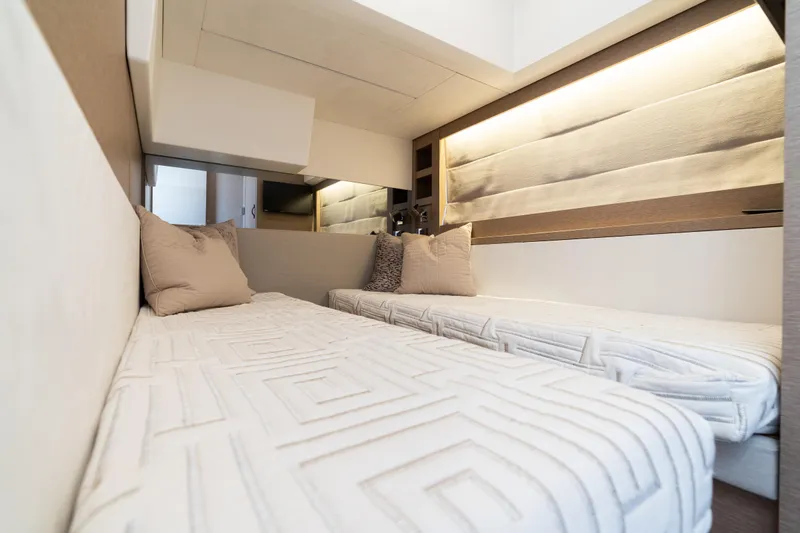 Motivated Seller Yacht Photos Pics Luxurious twin cabin interior of 2019 Prestige 520 yacht with modern design and cozy bedding.