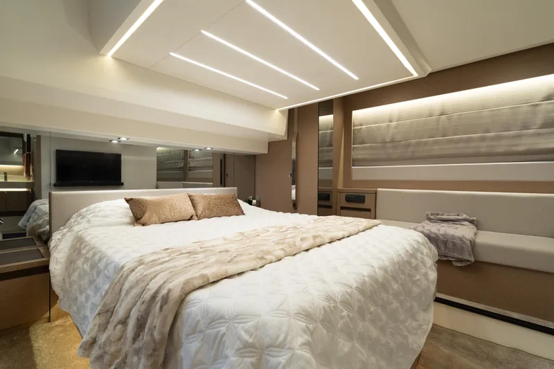 Motivated Seller Yacht Photos Pics Luxurious bedroom interior of 2019 Prestige 520 yacht with modern lighting and elegant decor.
