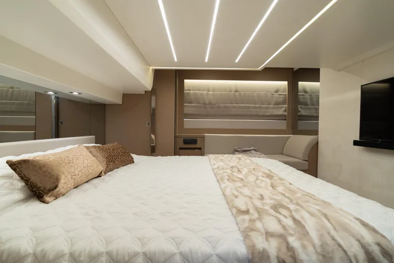 Motivated Seller Yacht Photos Pics Luxurious bedroom interior of 2019 Prestige 520 yacht with modern lighting and elegant decor.
