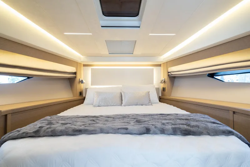 Motivated Seller Yacht Photos Pics Luxurious bedroom interior of 2019 Prestige 520 yacht with modern lighting and cozy bedding.