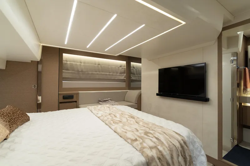 Motivated Seller Yacht Photos Pics Luxurious bedroom interior of 2019 Prestige 520 yacht with modern lighting and TV.