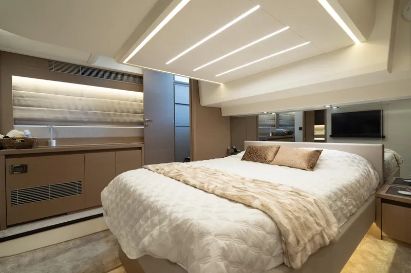 Motivated Seller Yacht Photos Pics Luxurious interior of a 2019 Prestige 520 yacht bedroom with modern design and cozy bedding.