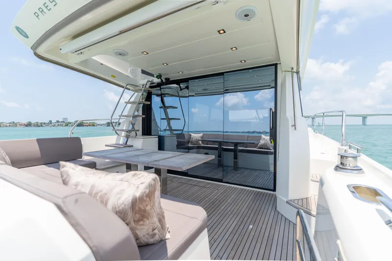 Motivated Seller Yacht Photos Pics Luxurious 2019 Prestige 520 yacht deck with seating, ocean view, and modern design.