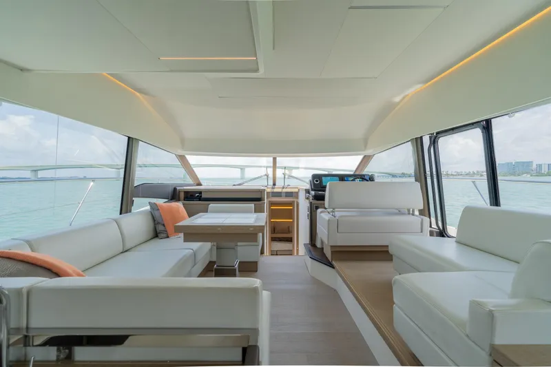 Motivated Seller Yacht Photos Pics Luxurious interior of a 2019 Prestige 520 yacht with modern seating and panoramic views.