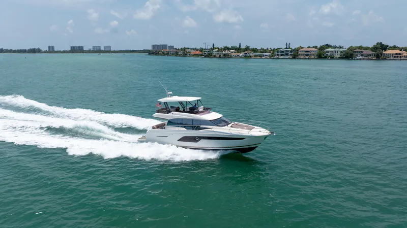 Motivated Seller Yacht Photos Pics 2019 Prestige 520 yacht cruising on a sunny day in open waters.
