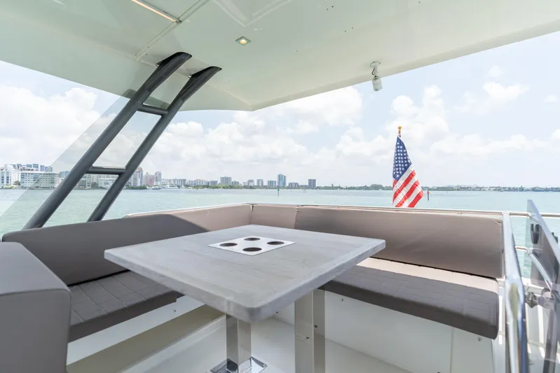Motivated Seller Yacht Photos Pics Luxury seating area on 2019 Prestige 520 yacht with ocean view and American flag.