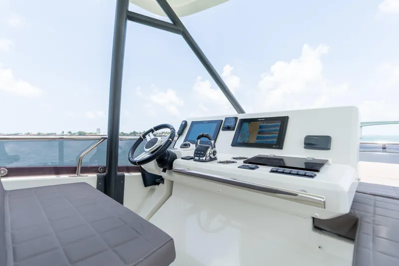Motivated Seller Yacht Photos Pics Prestige 520 yacht helm, 2019 model, featuring modern navigation equipment and luxurious seating.