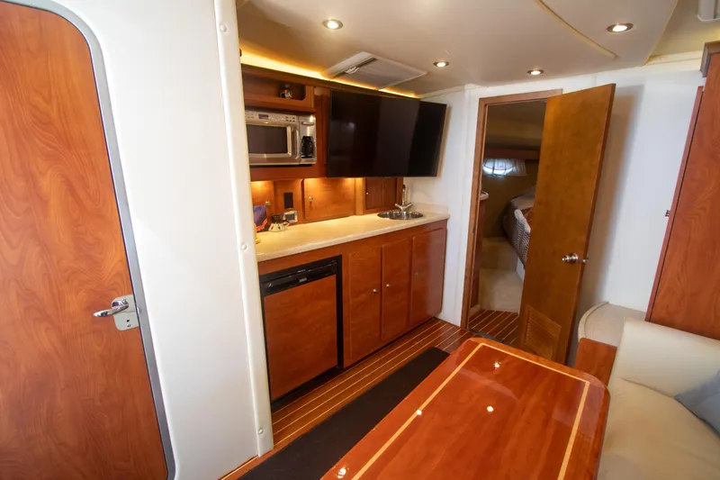 No Name Yacht Photos Pics Interior of 2008 Rinker 400 Express Cruiser with kitchenette and TV.