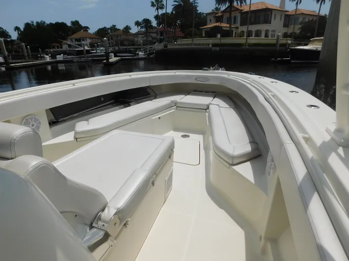  Yacht Photos Pics 2013 Hydra-Sports 4200 Siesta boat interior with white seating, docked near waterfront homes.