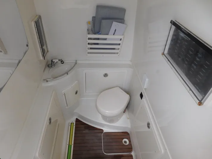  Yacht Photos Pics 2013 Hydra-Sports 4200 Siesta boat bathroom with toilet, sink, and wooden floor.