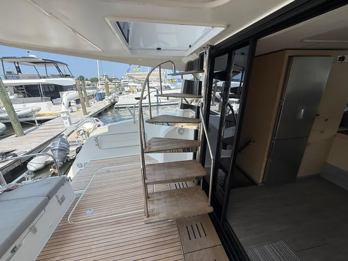 A New Hope Yacht Photos Pics 2018 Fountaine Pajot MY 44 yacht interior with spiral staircase and marina view.
