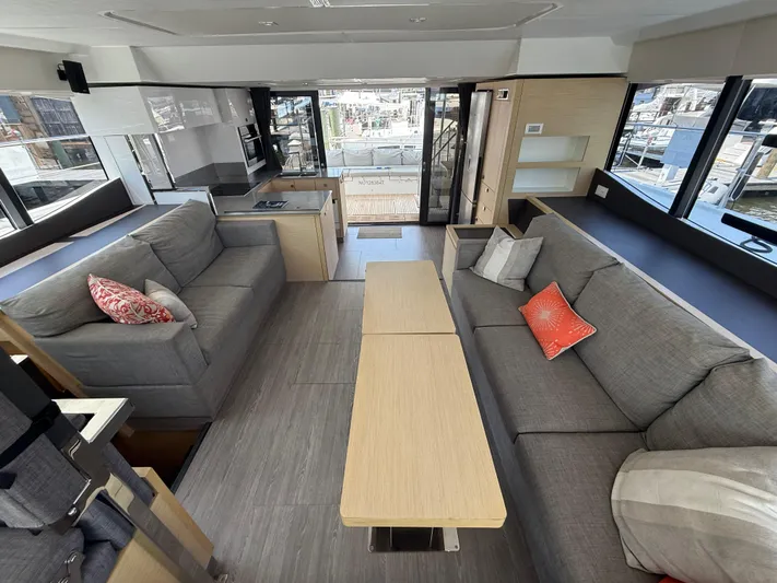 A New Hope Yacht Photos Pics Luxurious interior of 2018 Fountaine Pajot MY 44 yacht with modern furnishings and large windows.