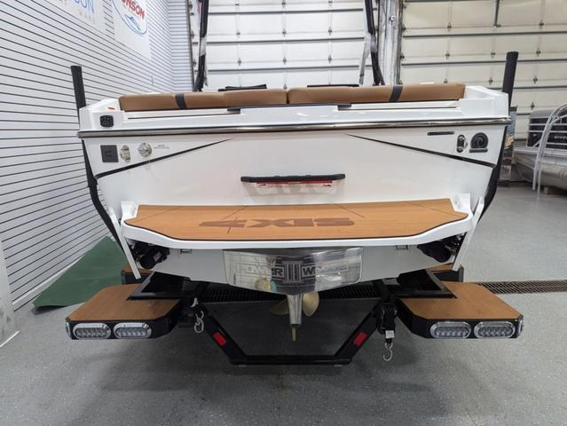 2025 Axis Wake Research T220 boat, rear view in a showroom setting.