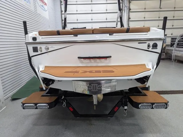 2025 Axis Wake Research T220 boat, rear view in a showroom setting.