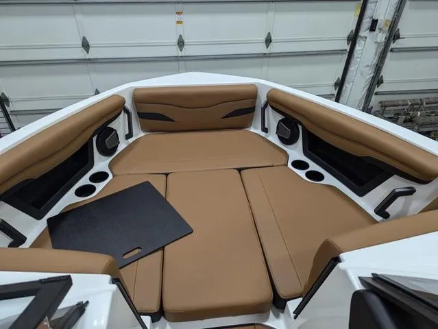 2025 Axis Wake Research T220 boat interior with tan seating and cup holders.