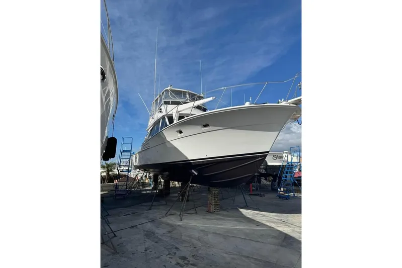  Yacht Photos Pics 1979 Bertram 46.6 Sport Fisher boat on dry dock under clear blue sky.