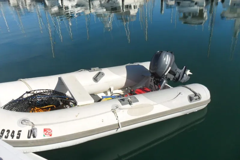 Yacht Photos Pics Inflatable boat with Yamaha motor docked on calm water, near Bertram 46.6 Sport Fisher.
