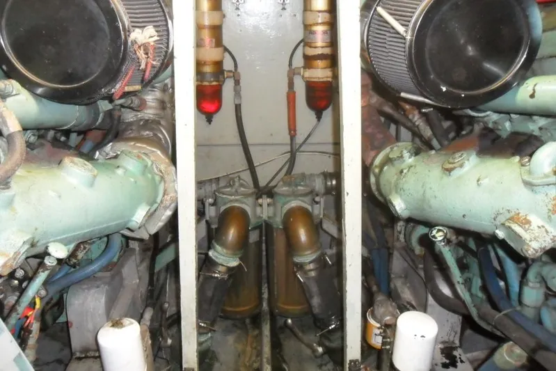  Yacht Photos Pics Engine room of a 1979 Bertram 46.6 Sport Fisher, showcasing dual engines and components.