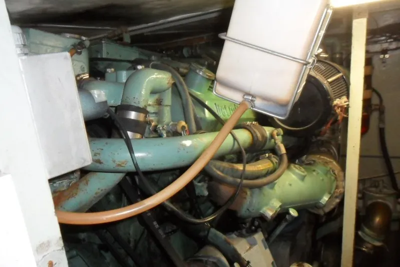  Yacht Photos Pics Engine room of a 1979 Bertram 46.6 Sport Fisher boat, showcasing mechanical components.