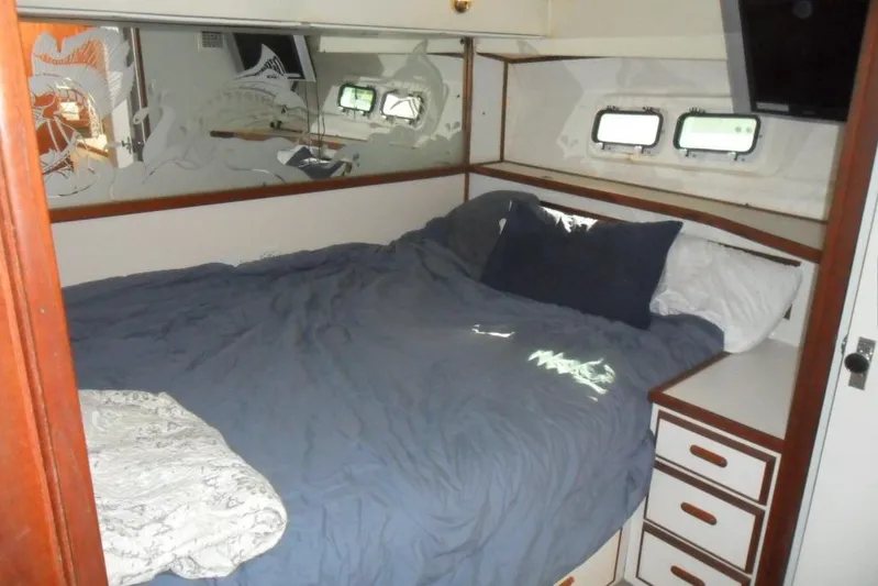  Yacht Photos Pics Interior cabin of 1979 Bertram 46.6 Sport Fisher with bed and porthole windows.