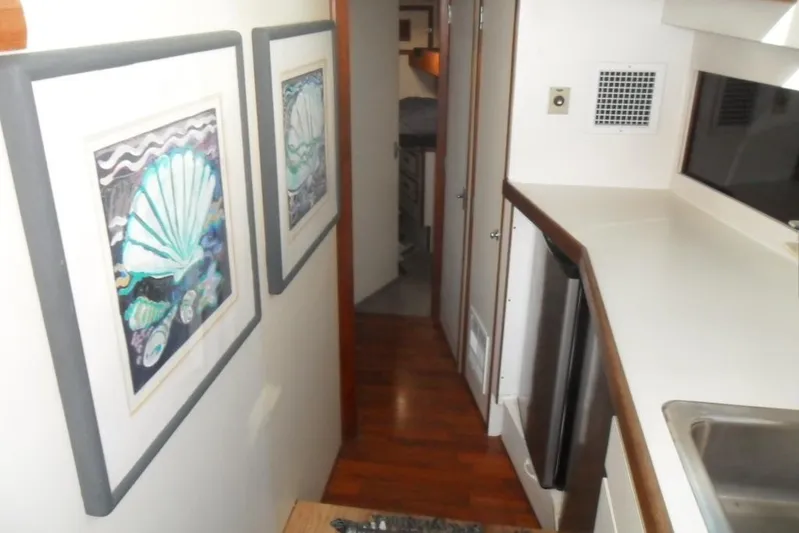  Yacht Photos Pics Interior of 1979 Bertram 46.6 Sport Fisher with artwork and kitchenette.