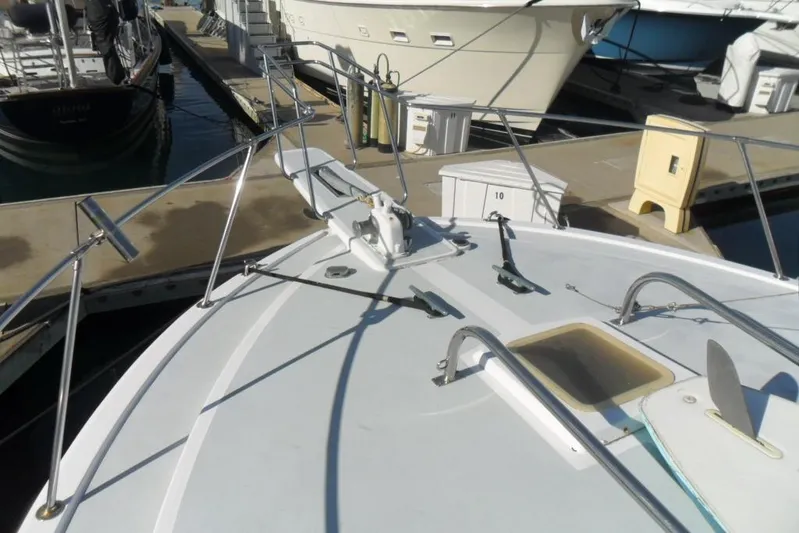  Yacht Photos Pics 1979 Bertram 46.6 Sport Fisher boat docked at marina, showing bow and deck details.
