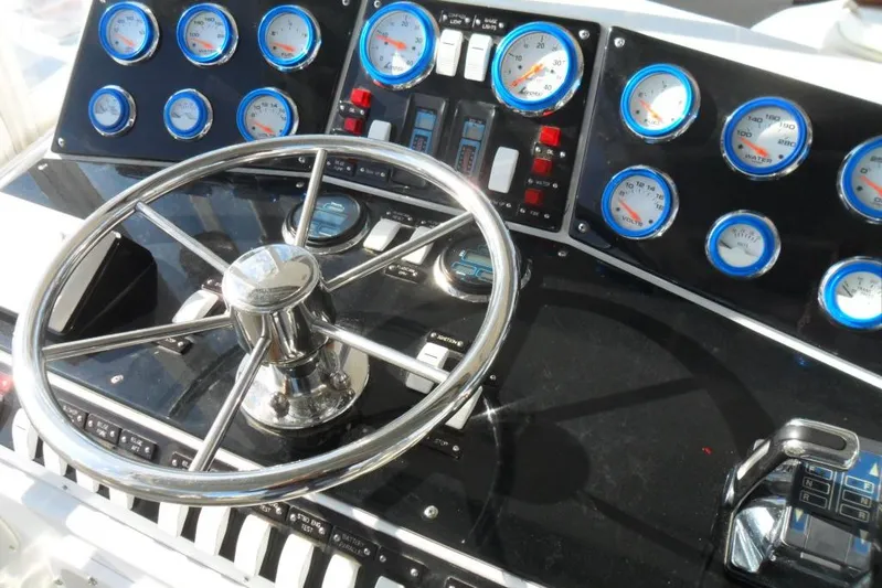  Yacht Photos Pics 1979 Bertram 46.6 Sport Fisher dashboard with steering wheel and gauges.