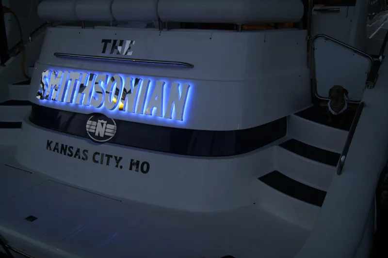  Yacht Photos Pics 1999 Neptunus 54 Hardtop Express yacht with illuminated name "Smithsonian," docked in Kansas City, MO.