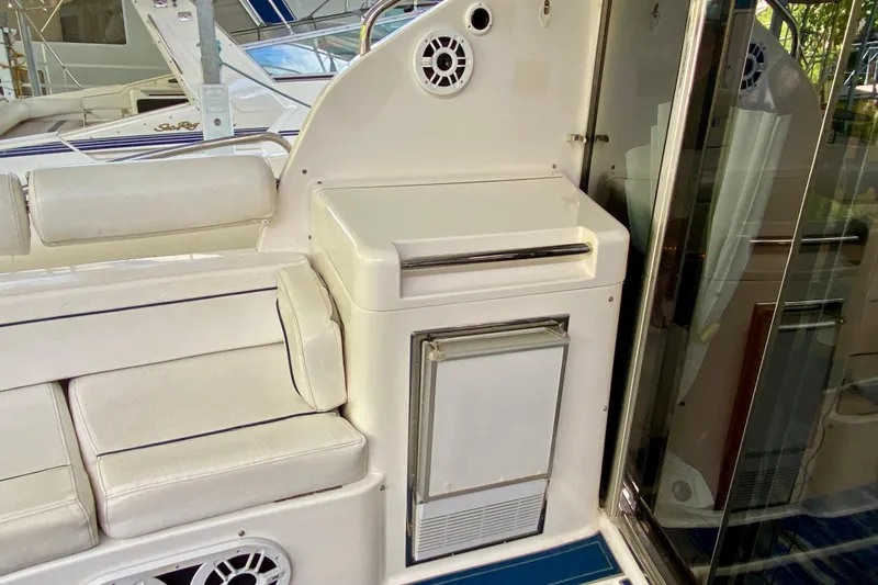  Yacht Photos Pics 1999 Neptunus 54 Hardtop Express yacht interior with white seating and built-in storage.