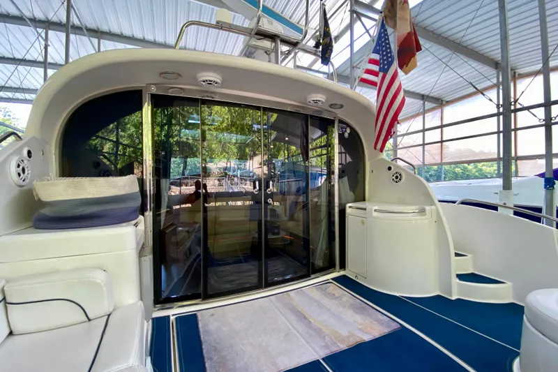  Yacht Photos Pics 1999 Neptunus 54 Hardtop Express yacht interior with glass doors and American flag.