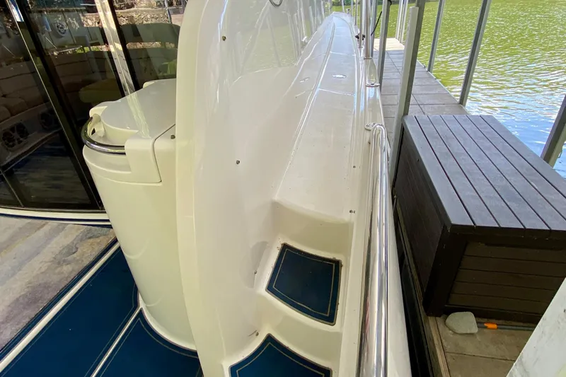  Yacht Photos Pics 1999 Neptunus 54 Hardtop Express yacht docked, showcasing sleek design and spacious deck area.