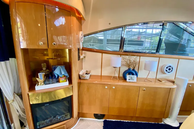  Yacht Photos Pics Interior of 1999 Neptunus 54 Hardtop Express yacht with elegant wood cabinetry and decor.