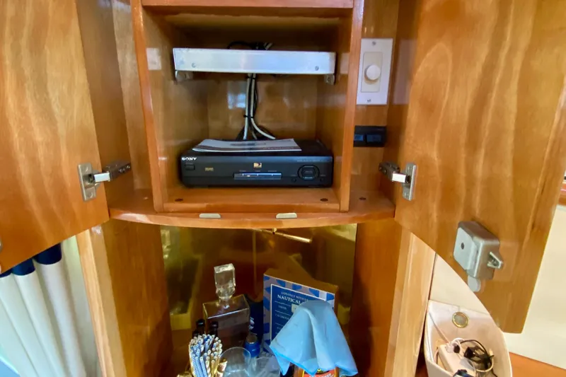  Yacht Photos Pics 1999 Neptunus 54 Hardtop Express interior cabinet with Sony DVD player and accessories.