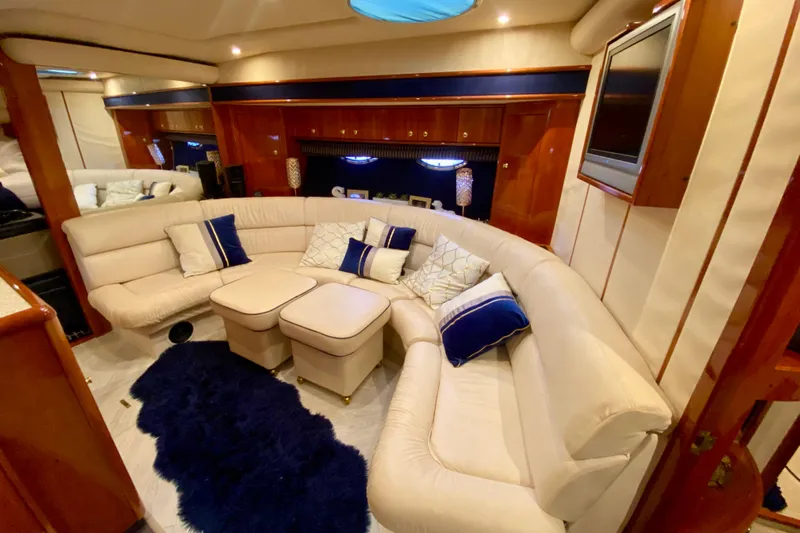  Yacht Photos Pics Luxurious interior of 1999 Neptunus 54 Hardtop Express yacht with plush seating and elegant decor.