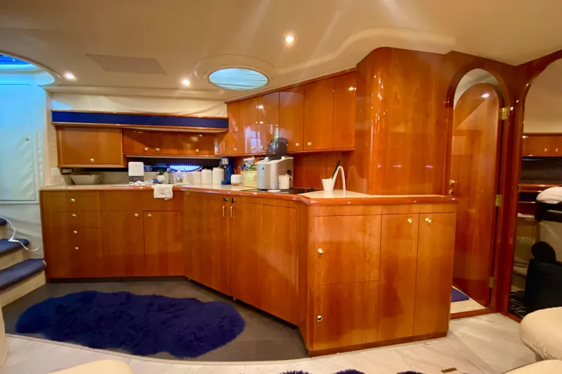  Yacht Photos Pics Luxurious wooden interior of 1999 Neptunus 54 Hardtop Express yacht kitchen area.